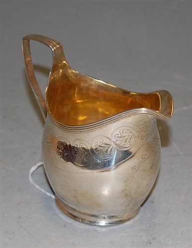 Lot 257 - A George III silver helmet shaped cream jug,...