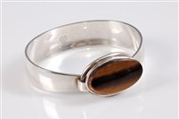 Lot 157 - A Danish silver and tigers eye bangle by Niels...