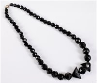 Lot 2573 - A jet bead necklace, the graduated faceted...