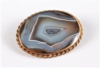 Lot 2597 - A 9ct agate specimen brooch, the oval...