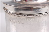 Lot 105 - A late Arts & Crafts hammered silver oval tea...