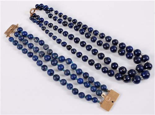 Lot 314 - A three strand lapis lazuli bracelet with...