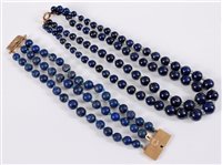 Lot 314 - A three strand lapis lazuli bracelet with...