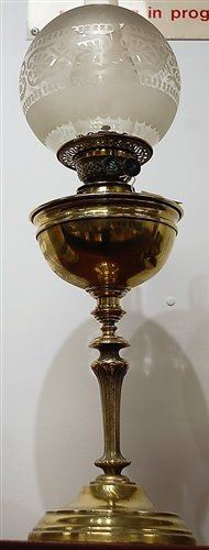 Lot 11 - An early 20th century brass pedestal oil lamp,...