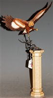 Lot 16 - A Franklin Mint model of an eagle perched on a...