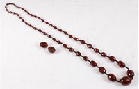 Lot 322 - A faux 'cherry amber' bead necklace, the...