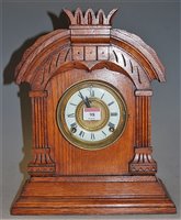 Lot 98 - A late 19th century oak cased mantel clock...