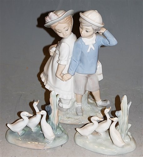 Lot 169 - A Lladro figure group of a boy and girl in...