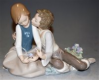 Lot 174 - A Lladro figure group boy & girl in seated...