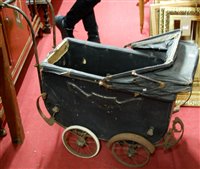 Lot 1071 - A vintage black painted wooden dolls pram