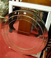 Lot 1099 - A contemporary circular wall mirror, together...