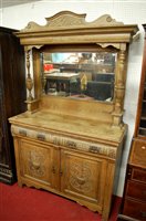 Lot 1110 - An early 20th century relief carved oak mirror...