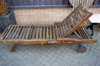 Lot 1123 - A contemporary stained and slatted teak...