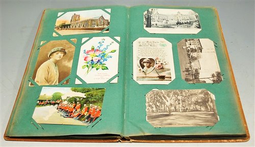 Lot 389 - A postcard album and contents, to include...