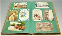 Lot 389 - A postcard album and contents, to include...