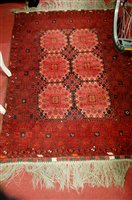 Lot 1134 - A Persian woollen red ground Bokhara rug,...