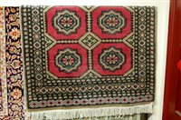 Lot 1137 - A Persian woollen pink ground Bokhara rug, 145...