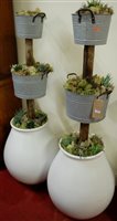 Lot 1145 - A pair of contemporary three tier planters,...