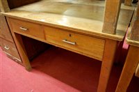 Lot 1165 - An early 20th century light oak two drawer...