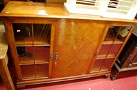 Lot 1169 - A 1920s figured walnut double door glazed...