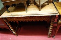 Lot 1205 - An early 20th century carved oak ledgeback...