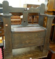 Lot 1220 - An early 20th cenutry oak boxseat settle, with...