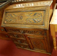 Lot 1228 - A late 19th century heavily carved oak...
