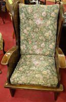 Lot 1270 - A joined oak wingback lambing chair, with...