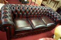Lot 1271 - A contemporary oxblood red leather button back...