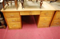 Lot 1236 - An early 20th century light oak kneehole...