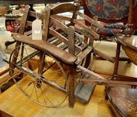 Lot 1258 - A rustic stained wood and slatted childs horse-...