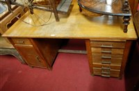 Lot 1259 - An early 20th century light oak kneehole...