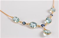 Lot 1155 - An aquamarine and sapphire necklace, the four...