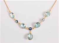 Lot 1155 - An aquamarine and sapphire necklace, the four...