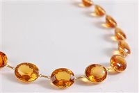 Lot 1210 - A citrine riviere necklace, the oval spectacle...