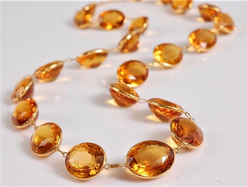 Lot 1210 - A citrine riviere necklace, the oval spectacle...