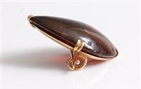 Lot 2502 - An 18ct amber brooch, the pear shaped amber...