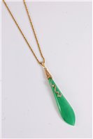 Lot 1182 - A jade and diamond pendant, the elongated...