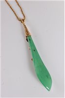 Lot 1182 - A jade and diamond pendant, the elongated...