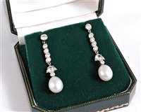 Lot 1197 - A pair of diamond and 'pearl' earrings, the...