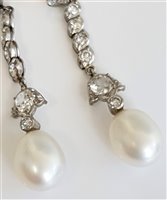 Lot 1197 - A pair of diamond and 'pearl' earrings, the...