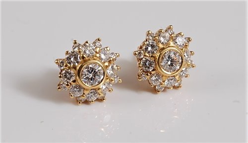 Lot 1174 - A pair of diamond cluster earrings, the...