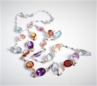 Lot 2614 - A mixed gemstone necklace, the oval faceted...