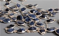 Lot 2669 - A long sapphire necklace, the mixed cut...