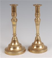 Lot 1258 - A pair of French 18th century turned brass...