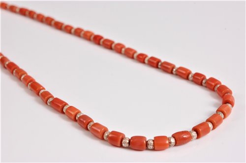 Lot 2582 - A coral and silver bead necklace, the barrel...