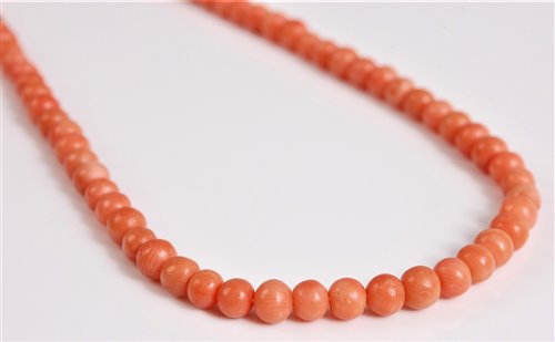 Lot 2585 - A coral bead necklace, the round coral beads,...