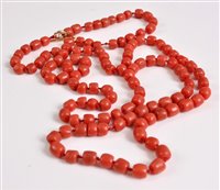Lot 2583 - A coral bead necklace, the barrel shaped coral...