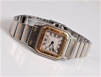 Lot 1223 - A lady's Cartier 18ct gold and steel Santos...