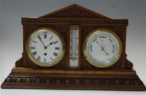 Lot 19 - A late Victorian carved oak cased clock...